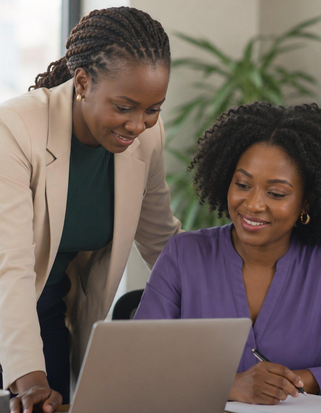 Two women working together at a laptop